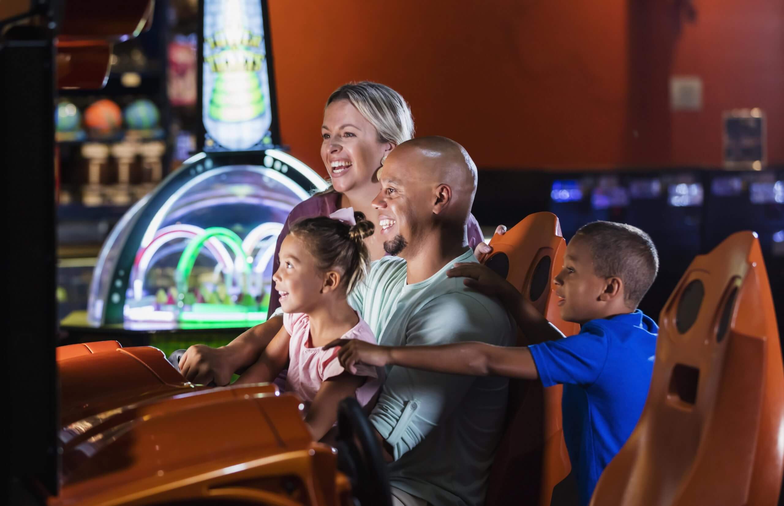 Happy Family Playing Racing Car Arcade