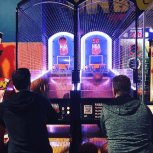 Two adults playing basketball arcade